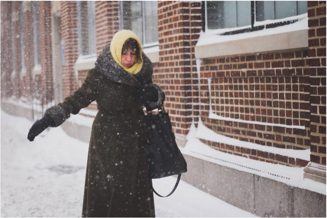Woman walking unbalanced on snow. Personal Injury.