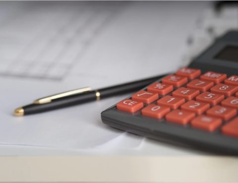 Paperwork, pen, and calculator personal injury compensation