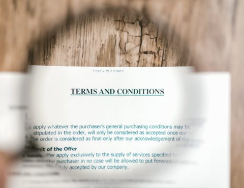 Terms and condictions contract through a magnifying glass